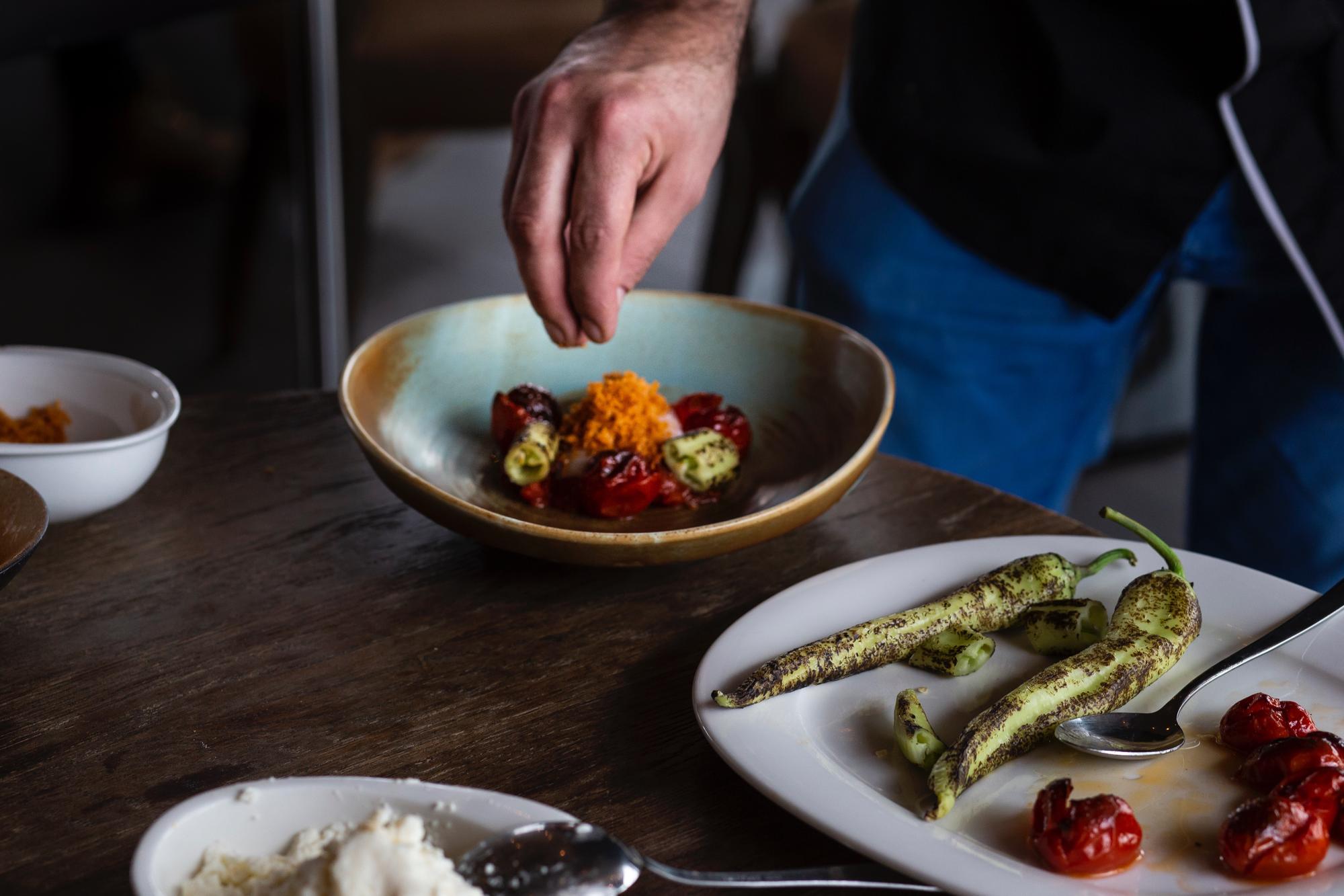Chef arranging tasting plates on wooden table